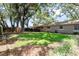 Well-maintained backyard with green lawn and partial fencing for privacy, enhancing outdoor living at 616 Pawn Way, Seffner, FL 33584