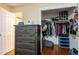 View of walk in closet, hanging racks, shelves and dark wood dresser at 616 Pawn Way, Seffner, FL 33584