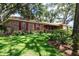Charming home featuring a well-manicured front yard with lush greenery and mature trees for added curb appeal at 616 Pawn Way, Seffner, FL 33584