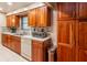 Kitchen showcasing stainless steel appliances, wood cabinets, and tiled backsplash at 616 Pawn Way, Seffner, FL 33584