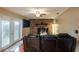 Comfortable living area with a stone fireplace, ceiling fan, and sliding glass doors at 616 Pawn Way, Seffner, FL 33584