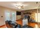 Cozy living room featuring a stone fireplace, ceiling fan, and access to the backyard at 616 Pawn Way, Seffner, FL 33584