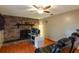 Relaxing living room space with a stone fireplace and wood-look flooring at 616 Pawn Way, Seffner, FL 33584