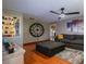 Comfortable living room with hardwood floors, a large gray sofa, and stylish decor, creating a welcoming space at 616 Pawn Way, Seffner, FL 33584