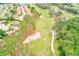 Scenic aerial view of a golf course featuring lush green fairways, sand traps, and mature trees at 6250 Fairskies Dr, New Port Richey, FL 34655