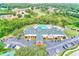 Aerial view of the clubhouse and pool area, nestled within a lush, wooded community, offering a tranquil setting at 6250 Fairskies Dr, New Port Richey, FL 34655
