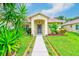 Charming single-story home with a well-manicured lawn and inviting entryway at 6250 Fairskies Dr, New Port Richey, FL 34655