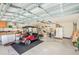 Spacious garage with golf cart, storage cabinets, and work area at 6250 Fairskies Dr, New Port Richey, FL 34655