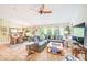 Living room featuring large sectional sofa and dining area beyond at 6250 Fairskies Dr, New Port Richey, FL 34655