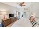 This main bedroom features an en-suite bath, ceiling fan, patio access, and an open layout at 6250 Fairskies Dr, New Port Richey, FL 34655