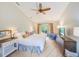This spacious main bedroom offers patio access, natural light, a ceiling fan, and an en-suite bathroom at 6250 Fairskies Dr, New Port Richey, FL 34655