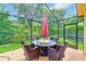 Comfortable outdoor dining and entertaining space inside screened lanai, with great view at 6250 Fairskies Dr, New Port Richey, FL 34655