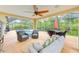 Enjoy the outdoor living space, complete with a patio, furniture, fan and view of the pool at 6250 Fairskies Dr, New Port Richey, FL 34655