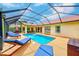 Sparkling screened-in pool with outdoor seating and lounge chairs at 6250 Fairskies Dr, New Port Richey, FL 34655