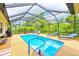 Enclosed pool area with a safety handrail and a view of the green landscaping at 6250 Fairskies Dr, New Port Richey, FL 34655