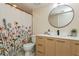 Cozy bathroom featuring floral shower curtain, modern vanity, round mirror, and tile flooring at 6263 93Rd N Ter # 4202, Pinellas Park, FL 33782