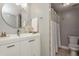 Bright bathroom featuring a modern vanity with a round mirror and a shower with a neutral-toned curtain at 6263 93Rd N Ter # 4202, Pinellas Park, FL 33782