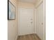 Inviting entryway with wood flooring, a six-panel door, and artwork on the wall at 6263 93Rd N Ter # 4202, Pinellas Park, FL 33782
