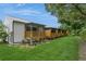 Backyard view showcasing multiple screened-in porches and a well-maintained lawn at 6263 93Rd N Ter # 4202, Pinellas Park, FL 33782