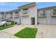 Exterior view features townhome with attached garage, balcony, and green space on the driveway at 6263 93Rd N Ter # 4202, Pinellas Park, FL 33782