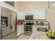 Modern kitchen with stainless steel appliances, white cabinets, and marble countertops at 6263 93Rd N Ter # 4202, Pinellas Park, FL 33782