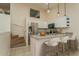 Well-lit kitchen features stainless steel appliances, granite counters, breakfast bar, and stairs leading up at 6263 93Rd N Ter # 4202, Pinellas Park, FL 33782