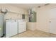 Functional laundry room equipped with a washer, dryer, and updated tile flooring at 6263 93Rd N Ter # 4202, Pinellas Park, FL 33782