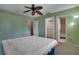 Bedroom showcasing the bed, fan, and access to the closet and bathroom at 6338 Newtown Cir # 38A6, Tampa, FL 33615