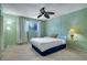 Bedroom with neutral carpet, a bed, ceiling fan, and natural light from the window at 6338 Newtown Cir # 38A6, Tampa, FL 33615