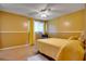 Bedroom featuring yellow walls, ceiling fan, window with curtains, and plush rug at 6338 Newtown Cir # 38A6, Tampa, FL 33615
