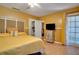 Bedroom featuring yellow walls, ceiling fan, closet, and sliding door to balcony at 6338 Newtown Cir # 38A6, Tampa, FL 33615