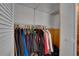 Open closet filled with clothes hanging on rods and shelving above at 6338 Newtown Cir # 38A6, Tampa, FL 33615