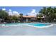 Community pool surrounded by lounge chairs, landscaping, and buildings at 6338 Newtown Cir # 38A6, Tampa, FL 33615