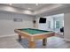 Spacious game room with a pool table and mounted TV, perfect for entertaining friends and Gathering at 6338 Newtown Cir # 38A6, Tampa, FL 33615