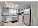 Kitchen featuring a double basin sink, tile backsplash, and a combination of gray and white cabinets at 6338 Newtown Cir # 38A6, Tampa, FL 33615