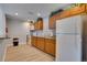 This bright kitchen features updated appliances, granite countertops, and custom wood cabinets at 6338 Newtown Cir # 38A6, Tampa, FL 33615