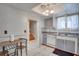 Kitchen featuring white tile floors, two toned cabinets, and stainless steel sink at 6338 Newtown Cir # 38A6, Tampa, FL 33615