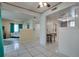 Open living space with white tile floors and view to the kitchen at 6338 Newtown Cir # 38A6, Tampa, FL 33615