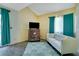 Cozy living room with white sofa, wood-look flooring, turquoise curtains, and vaulted ceiling at 6338 Newtown Cir # 38A6, Tampa, FL 33615