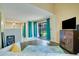 Living room featuring wood-look flooring, sliding glass doors, turquoise curtains, and white sofa at 6338 Newtown Cir # 38A6, Tampa, FL 33615