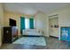Bright living room with wood-look flooring, white sofa, turquoise curtains, and vaulted ceiling at 6338 Newtown Cir # 38A6, Tampa, FL 33615