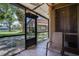 Screened-in patio with tiled floor offering views of landscaped exterior at 6338 Newtown Cir # 38A6, Tampa, FL 33615