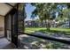 Screened-in patio overlooking landscaped exterior and views of complex at 6338 Newtown Cir # 38A6, Tampa, FL 33615