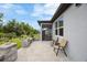 A comfortable patio with outdoor seating, leading to a well-maintained backyard at 6447 Bradford Woods Dr, Zephyrhills, FL 33542