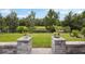 Lush backyard view highlighting professional landscaping and an iron fence at 6447 Bradford Woods Dr, Zephyrhills, FL 33542