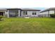 The home features a well-manicured backyard, a patio, and a fence at 6447 Bradford Woods Dr, Zephyrhills, FL 33542