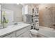 Modern bathroom features a vanity, tub, shower, and neutral color palette at 6447 Bradford Woods Dr, Zephyrhills, FL 33542