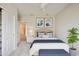 Tastefully decorated bedroom with a plush bed, stylish artwork, and a ceiling fan at 6447 Bradford Woods Dr, Zephyrhills, FL 33542