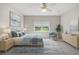 A beautifully decorated bedroom with a serene blue color scheme, carpeted floor and natural lighting at 6447 Bradford Woods Dr, Zephyrhills, FL 33542