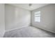 A bright bedroom features neutral walls, a ceiling fan, and a window at 6447 Bradford Woods Dr, Zephyrhills, FL 33542